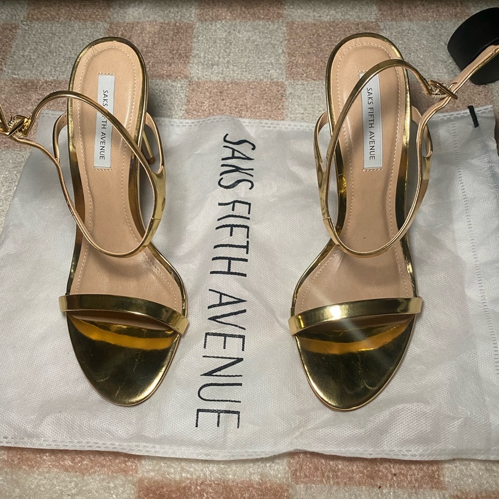 Women’s gold ankle strap stilleto sandal.